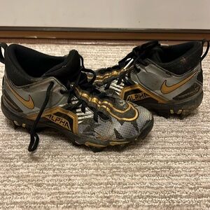 Used youth size 3 Nike Alpha Fastflex cleats black and gold